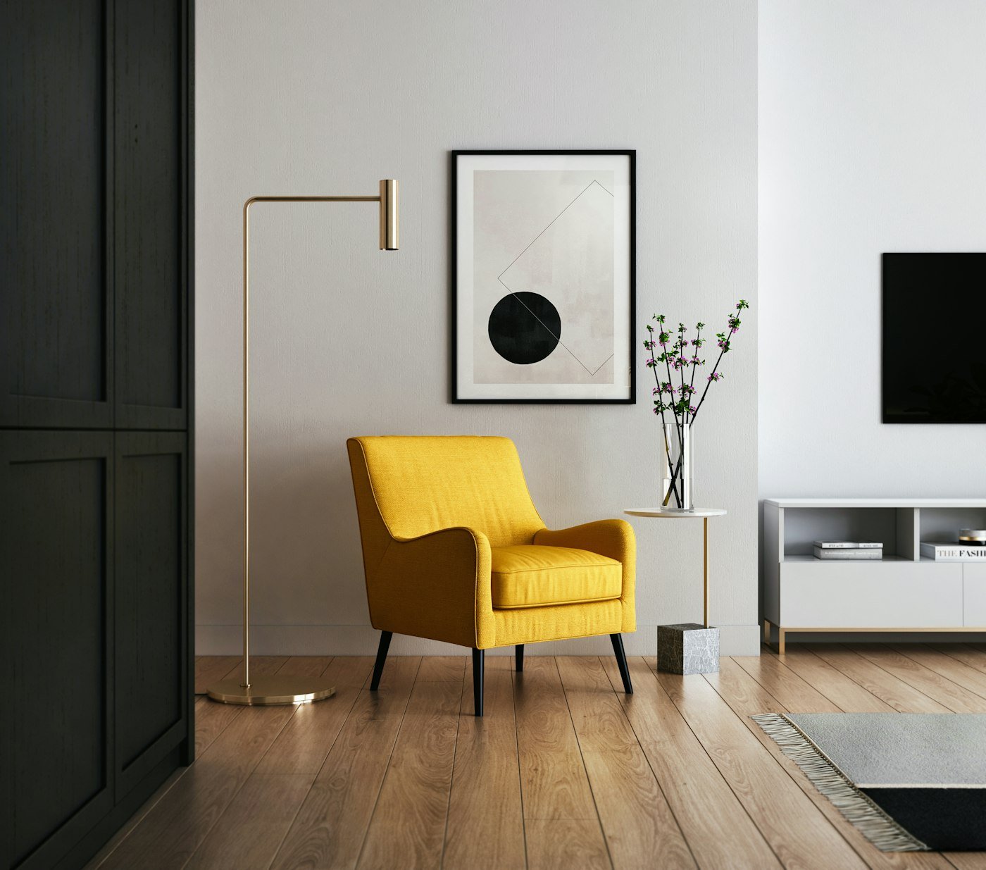 A mustard armchair, a brass floor lamp, and a framed print with a black circle